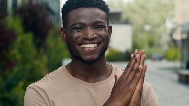 files/african-american-man-smiling-ethnic-guy-male-smile-toothy-happy-applauding-clapping-hands-expresses-high-appreciation-of-support-applause-in-city-outdoors-triumph-success-gratitude-su.jpg