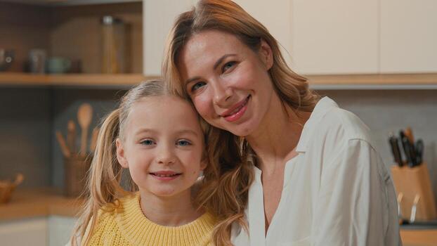files/caucasian-happy-family-at-kitchen-close-up-smiling-child-daughter-cuddling-mom-look-at-camera-adult-single-mother-foster-parent-and-adopted-cute-kid-girl-hug-cuddle-enjoy-sweet-tender.jpg